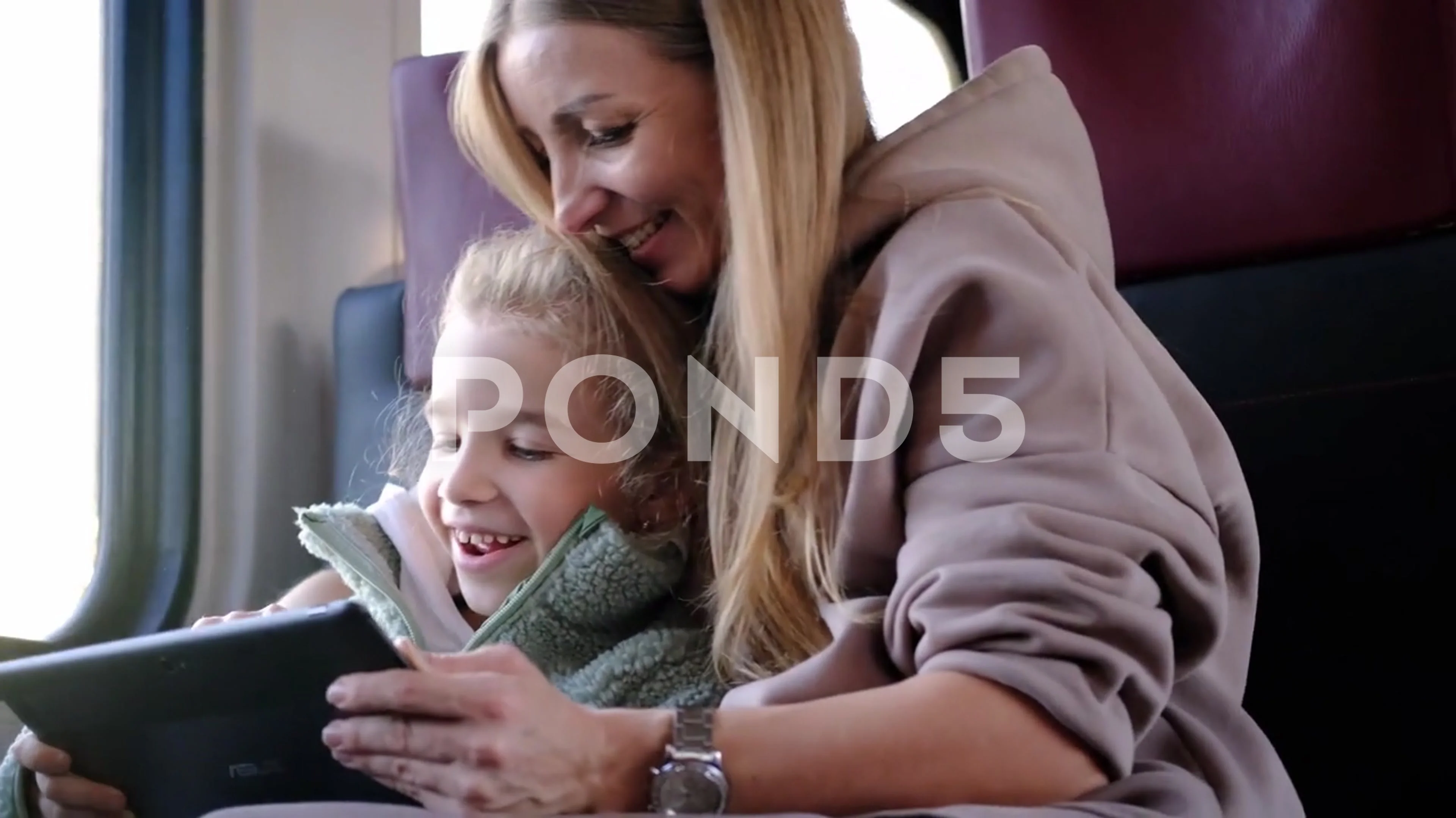 Mother and daughter play a game on a tablet- Minsk, Belarus, DEcember 10,  2021