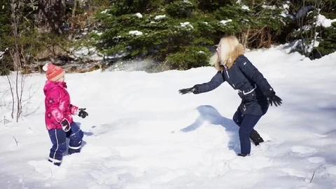 Mother and daughter playing in the snow Stock Footage 84142953