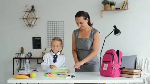 Mother and Daughter Preparing Backpack for School Stock Footage 157809775