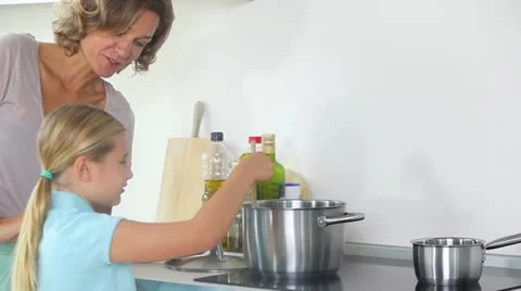 Mother and daughter preparing dinner Stock Footage