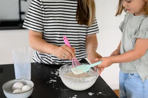 Mother and daughter preparing dough with flour Stock Photos