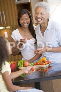 Mother and daughter preparing meal,mealtime together Stock Photos