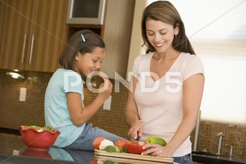 Mother and daughter preparing meal,mealtime together Stock Photos