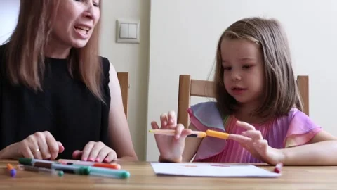 Mother and daughter sharing a creative moment Stock Footage 311624315