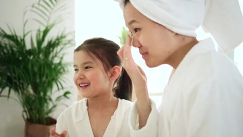 Mother and daughter skincare Asian girl with mom lotion Spbd Stock Footage