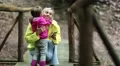 Mother and daughter with smartphone on the foot bridge HD Footage