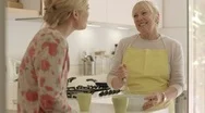 Mother And Daughter Talking, Drinking Coffee In Kitchen At Home Stock Footage