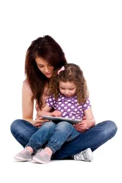 Mother and daughter using a computer tablet Stock Photos