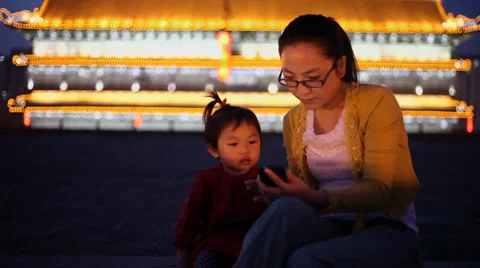 Mother and daughter using mobile phone on xi'an city wall, Xi'an, China. Stock Footage 36841873