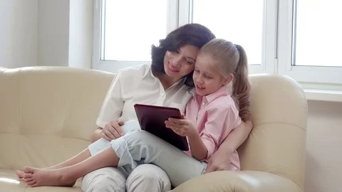 Mother and daughter using a tablet computer. Video stock 72176612
