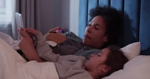 Mother and daughter using tablet at night Stock Footage 200931592
