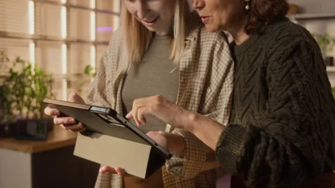 Mother and Daughter Using Tablet Computer for Online Shopping Video stock 338396145