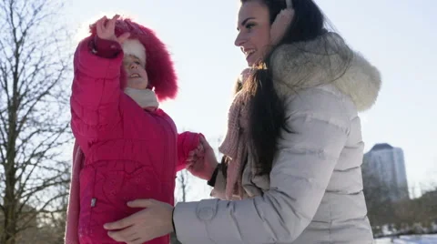 Mother and daughter walking in the park on a sunny winter day Stock Footage 59793655