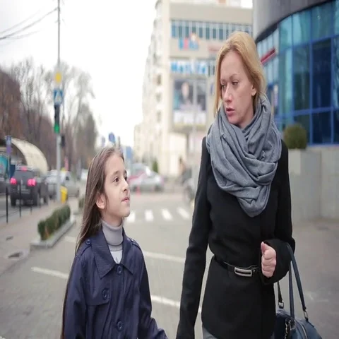 Mother and daughter walking on the street. cold autumn Stock Footage