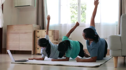 Mother and daughters doing exercise yoga together at home Stock Footage 287890106