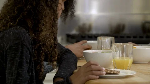 Mother and daughters having breakfast together. 스톡 동영상 88183261