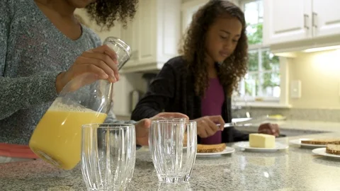 Mother and daughters preparing breakfast. Stock Footage 88161405