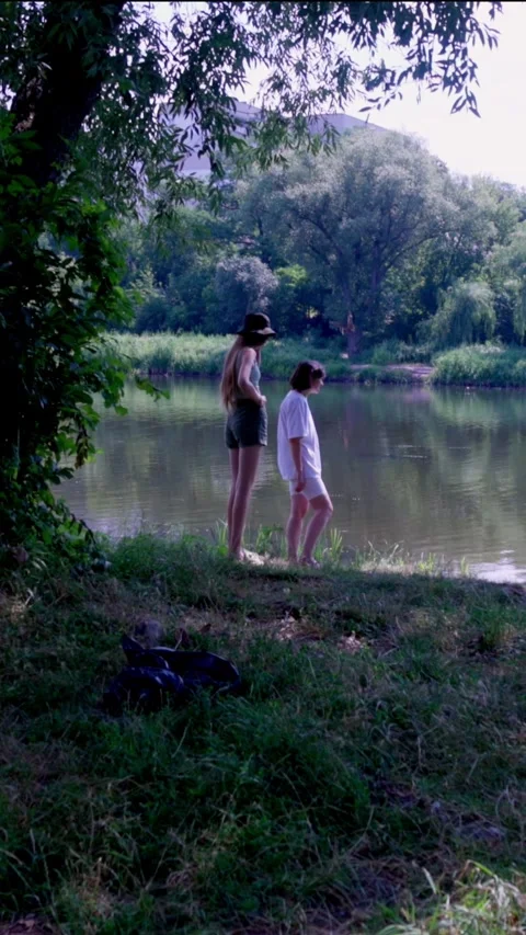 Mother and Daughters Standing Together on Clean Riverbank in Nature Stock Footage 340577250