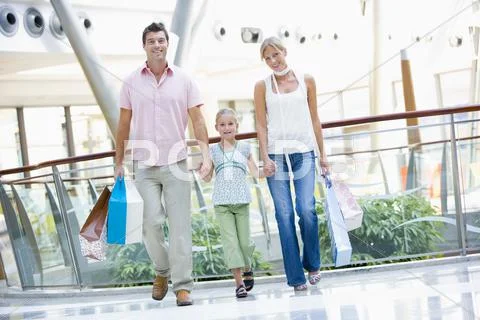 Mother and father with young daughter at a shopping mall Stock Photos