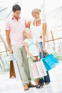 Mother and father with young daughter at a shopping mall Stock Photos