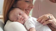 Mother And Grandmother With Sleeping Newborn Baby Daughter Stock Footage