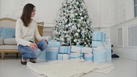 Mother and happy son checking gifts sitting near the Christmas tree Stock Footage 70869655