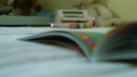Mother and her baby boy are reading book Stock Footage