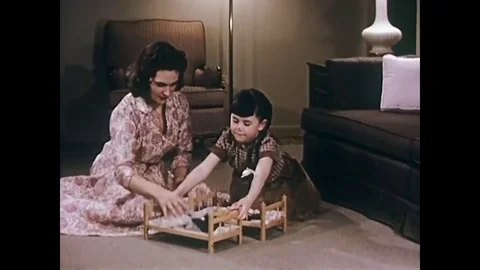 A mother and her child with a doll's bunk bed in their sitting room. Then black Stock Footage