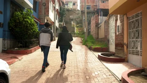 A mother and her son walking in a narrow street of Huaras in the morning going Video stock 164460880