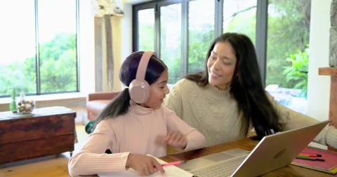 Mother and Indian child doing homework, mother walking phoning, fixing headset Stock Footage 344339645