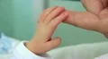 Mother and newborn daughter in maternity home. Hand in hand HD Footage