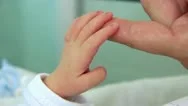 Mother And Newborn Daughter In Maternity Home. Hand In Hand Stock Footage