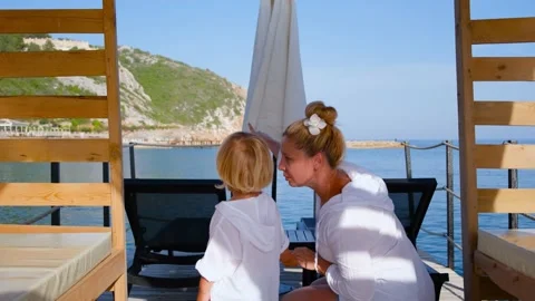 Mother and shows son something with a finger in white shirts Stock Footage 200784559