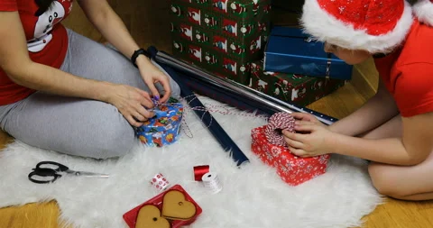 Mother and son are preparing Christmas presents for Christmas Video stock 98917494