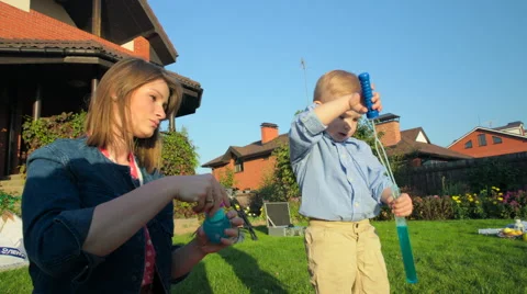 Mother and Son Blowing Soap Bubbles Stock Footage 56239940