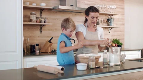 Mother and son bonding in kitchen Video stock 60789942