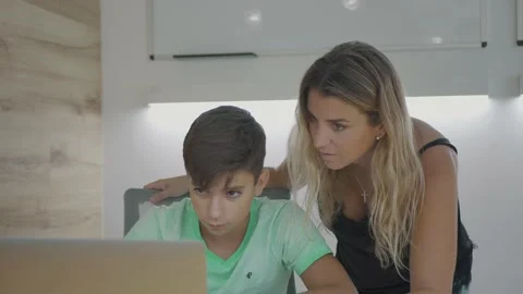 Mother and son boy using laptop for doing homework and remote school 스톡 동영상 142862083