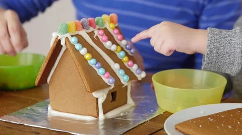 A mother and son decorating gingerbread house Stock Footage 59723319