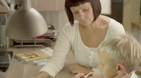 Mother and son doing homework and getting ready for school Stock Footage 62915621