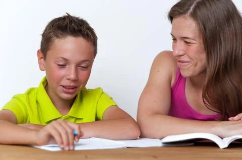 Mother and son doing homework lessons together Stock Photos