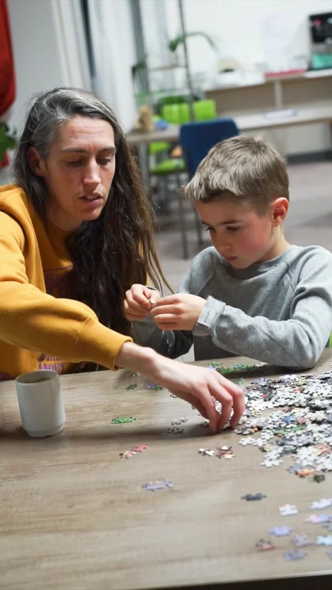 Mother and son doing a puzzle together Stock Footage 261719476
