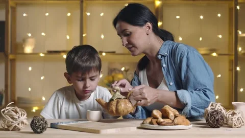 Mother and son drinking tea and eating buns and croissant Stock Footage 143618679