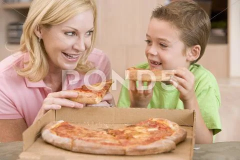 Mother and son eating pizza together Stock Photos