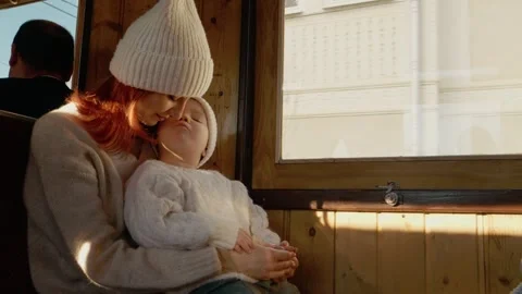 Mother and son enjoy a train journey through mountains in an old train Stock Footage 346717497