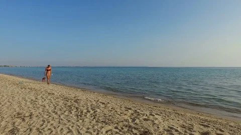 Mother and son enjoying while walking on the beach on a hot sunny day Stock Footage 84742507