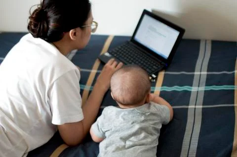A mother and son is in front of a computer Stock Photos