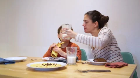 Mother and son having breakfast together at home Stock Footage 270152695