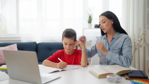 Mother and son having difficulty with school homework, challenging math problem Stock Footage 224957814