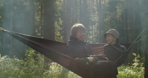 Mother and son having fun laughing together on green nature background slow Stock Footage 156167039