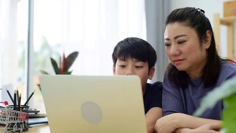 Mother and son laughing while looking computer laptop. Stock Footage 83051770
